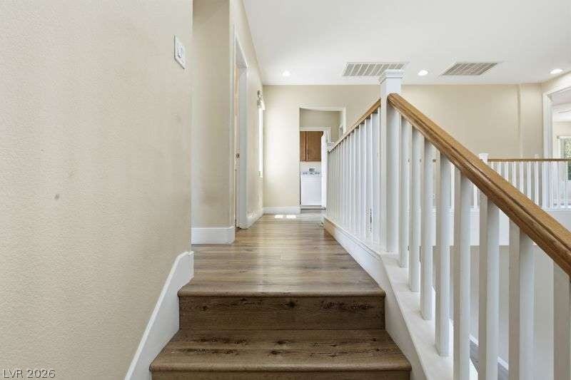 10464 Calico Pines Avenue, Las Vegas, NV 89135 A spacious upper landing connects the staircase to adjacent rooms with polished wood flooring.