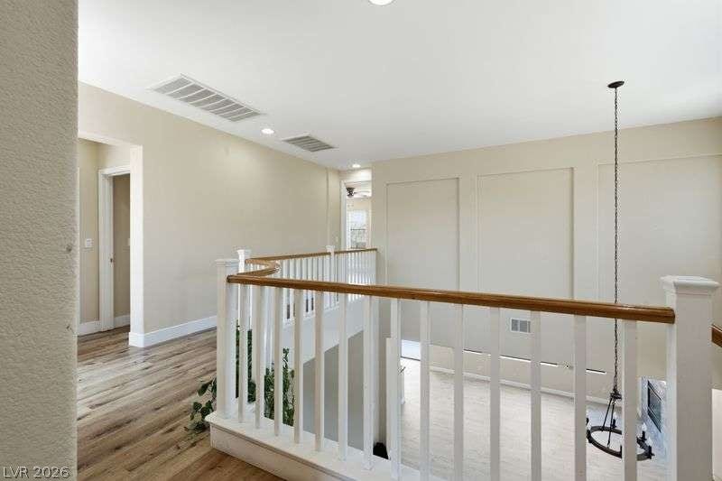 10464 Calico Pines Avenue, Las Vegas, NV 89135 An open upper level features classic wooden railings overlooking the living area below.