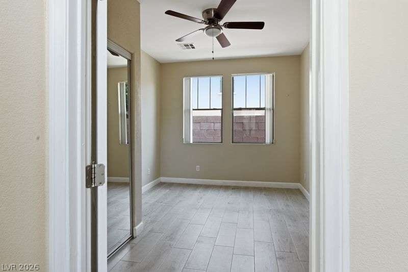 10464 Calico Pines Avenue, Las Vegas, NV 89135 Plank flooring and dual windows define this comfortable secondary bedroom.