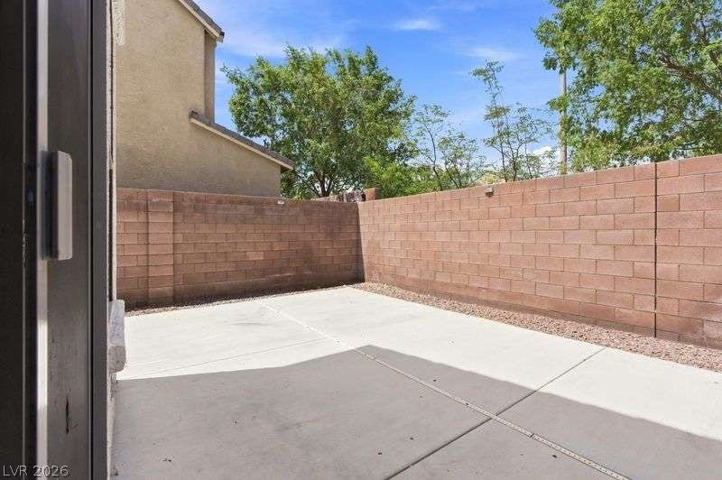 10464 Calico Pines Avenue, Las Vegas, NV 89135 A private concrete patio sits enclosed by high block walls under clear blue skies.