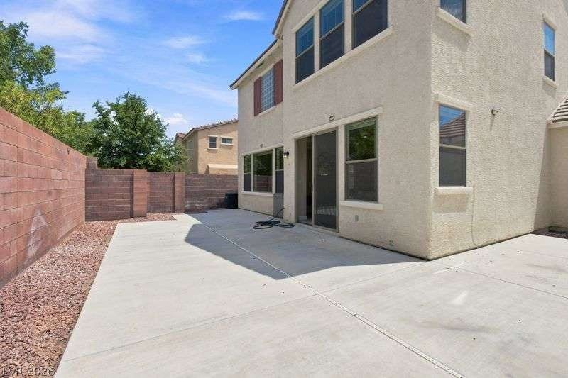 10464 Calico Pines Avenue, Las Vegas, NV 89135 A spacious concrete patio highlights this enclosed backyard area.