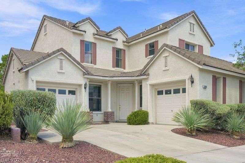 10464 Calico Pines Avenue, Las Vegas, NV 89135 Stucco walls and tiled roofs create a classic exterior with integrated garage spaces.