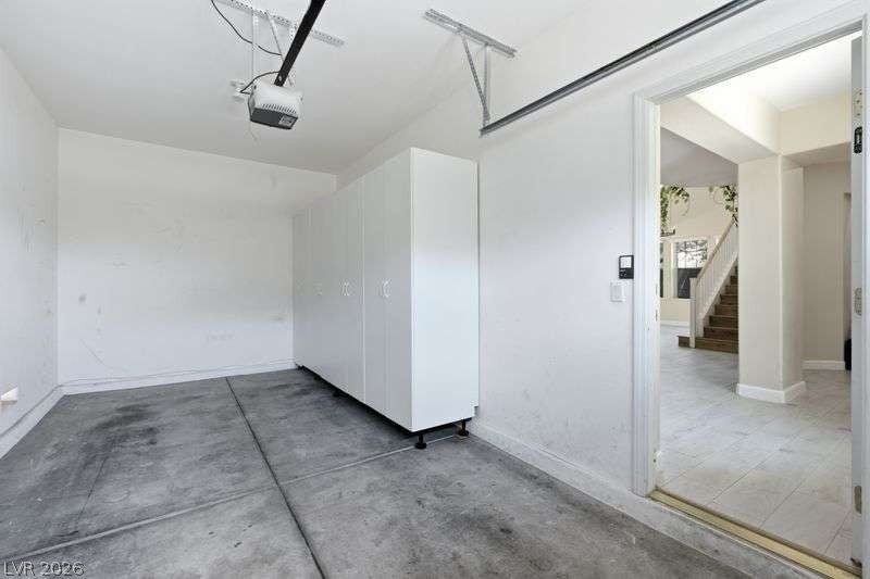 10464 Calico Pines Avenue, Las Vegas, NV 89135 Ample built-in storage cabinets line the wall of this functional garage space.