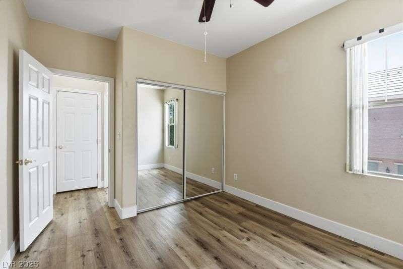 10464 Calico Pines Avenue, Las Vegas, NV 89135 Rich wood-plank flooring and mirrored closets enhance this inviting bedroom space.