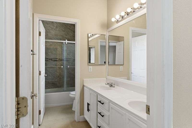 10464 Calico Pines Avenue, Las Vegas, NV 89135 Double vanity sinks and clean cabinetry accent this functional bathroom layout.