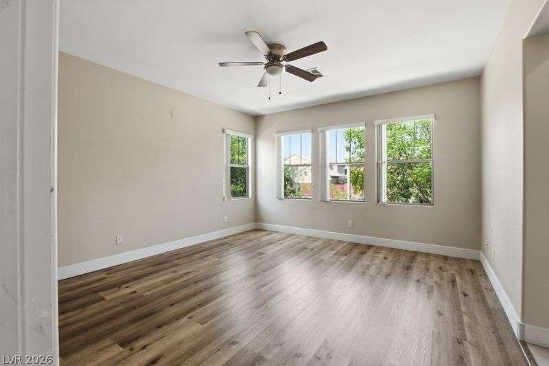 10464 Calico Pines Avenue, Las Vegas, NV 89135 Gleaming wood-look floors anchor this airy space illuminated by multiple picture windows.