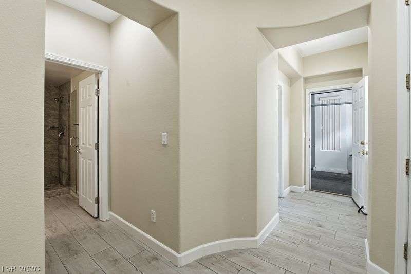 10464 Calico Pines Avenue, Las Vegas, NV 89135 Gleaming tile floors and architectural archways define this welcoming hallway transition.