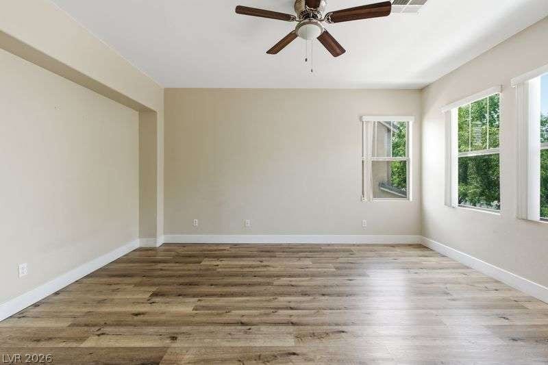 10464 Calico Pines Avenue, Las Vegas, NV 89135 Rich wood-inspired flooring and clean white baseboards anchor this versatile living space.