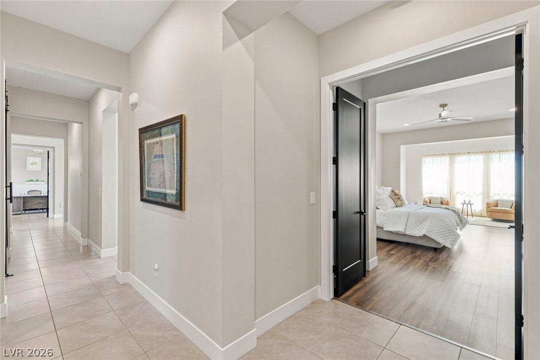 Clean modern lines connect the hallway to a spacious bedroom retreat.