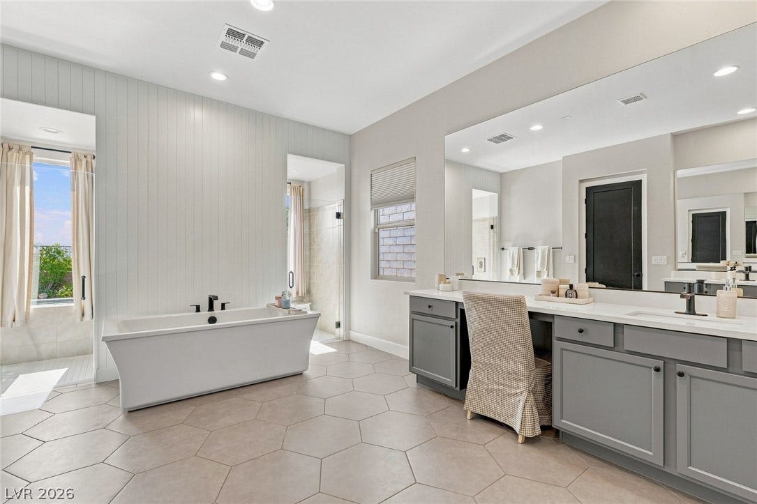 Two separate vanities, one side features an elongated makeup area.