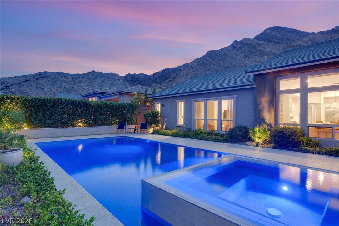 Dramatic mountain views provide a scenic backdrop for the custom pool and spa.
