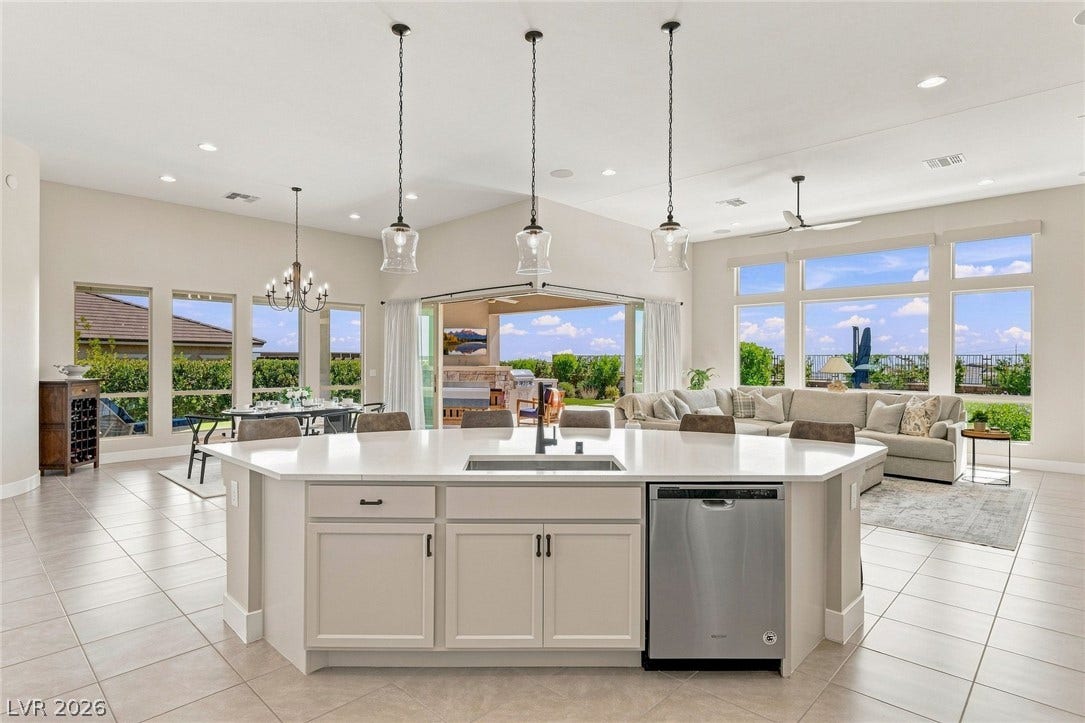 An open floorplan seamlessly connects the airy kitchen to a spacious main living area.