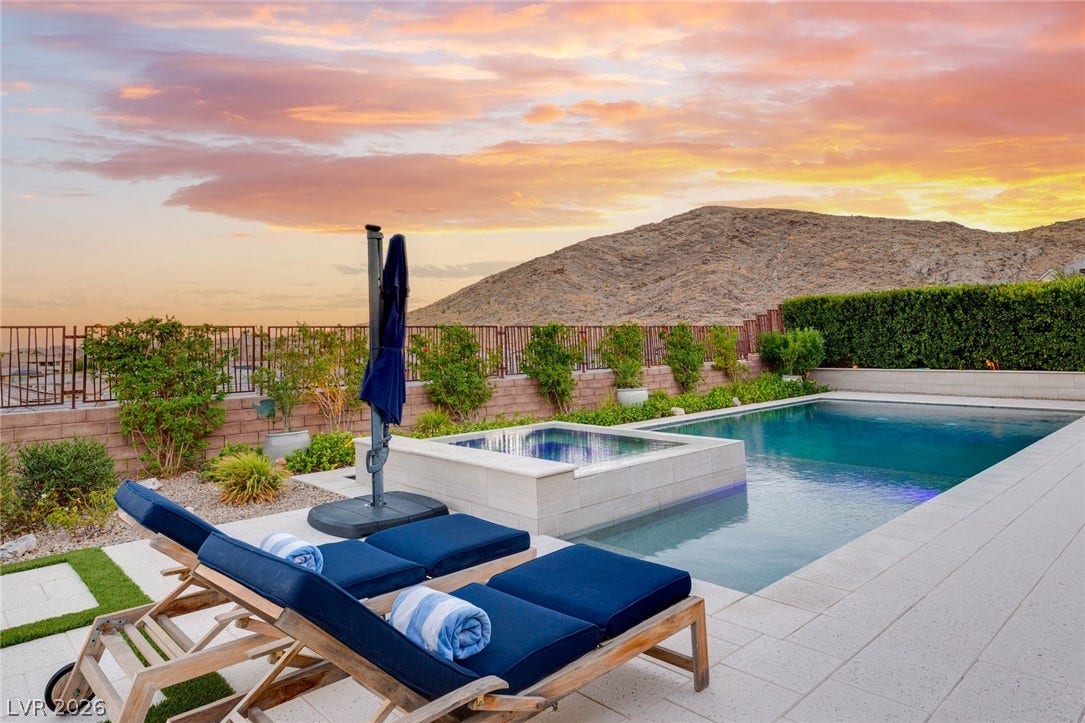 An inviting backyard pool and integrated spa enjoy serene, open mountain views.