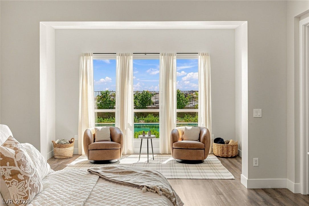 Enjoy the pool views from the primary bedroom's retreat.
