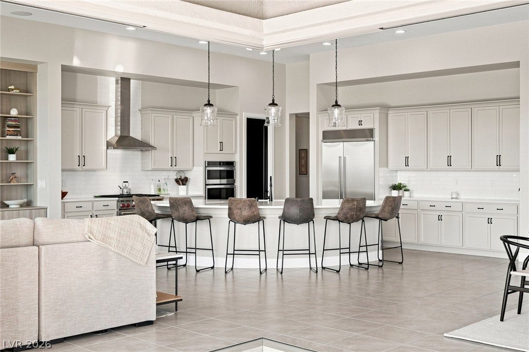 Gourmet kitchen features an oversized island and custom cabinetry.