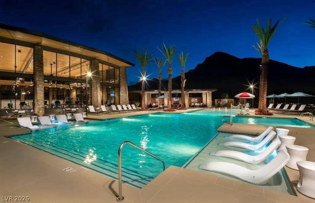 Resort style pool with beach entry, multiple wet decks and cabanas.