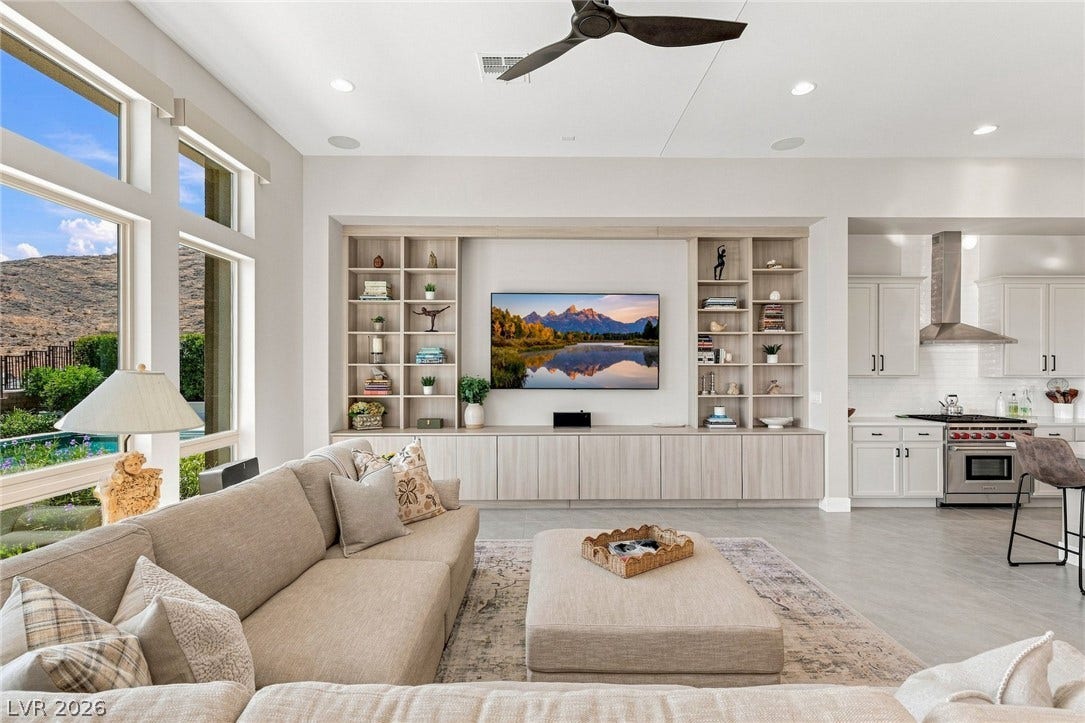 An open floor plan seamlessly connects the main living space with custom built-ins and the kitchen.