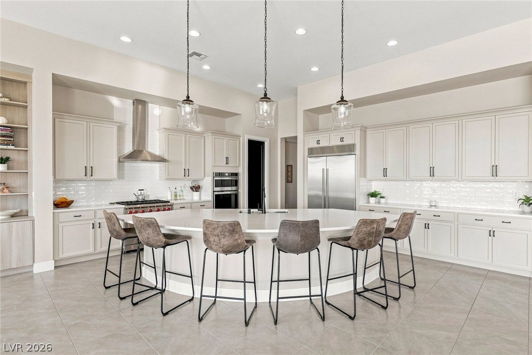 Gourmet kitchen features an oversized island and custom cabinetry.