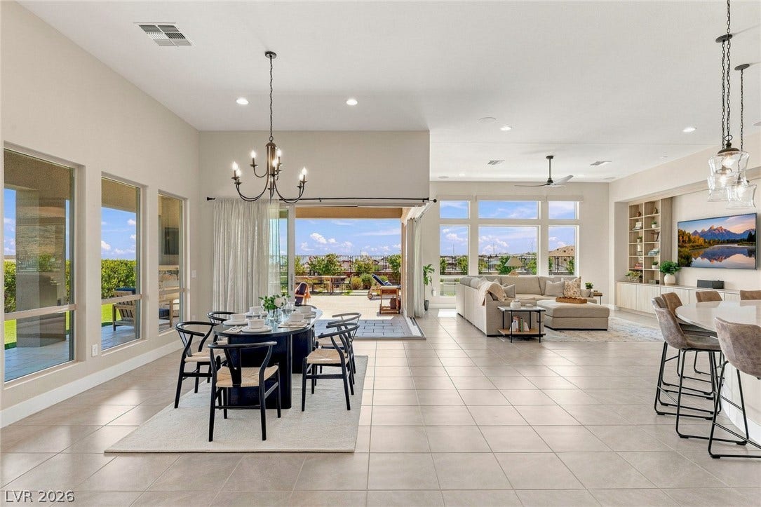 High ceilings and a corner slider define this seamless indoor-outdoor living space.
