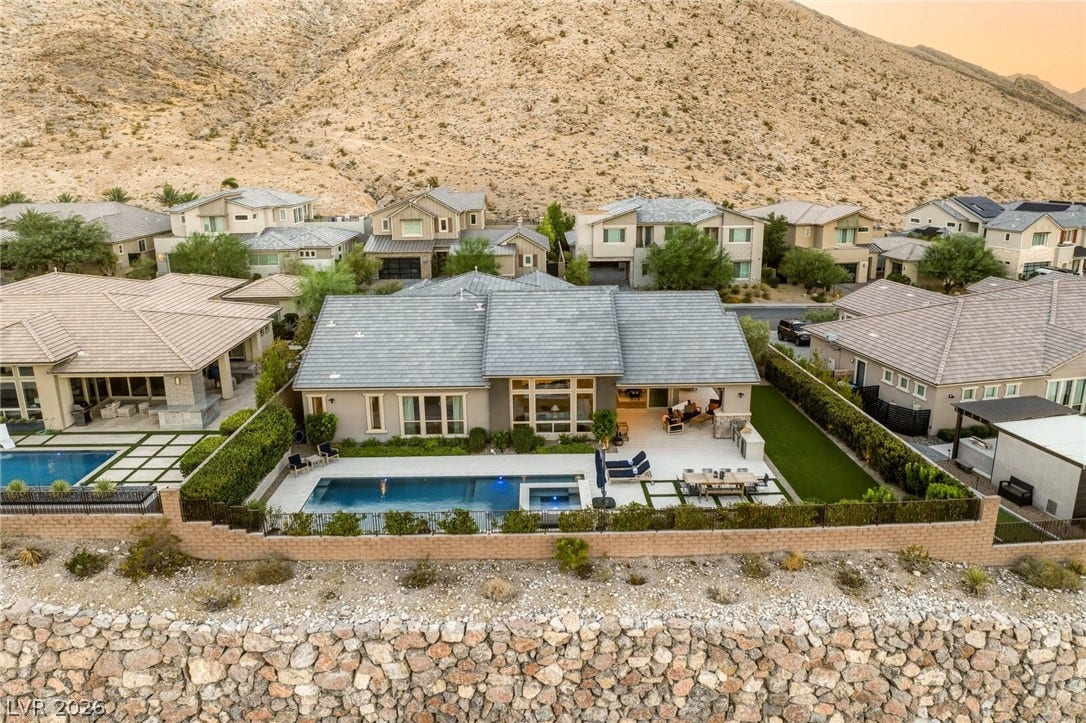 Dramatic mountain backdrops frame this modern desert home