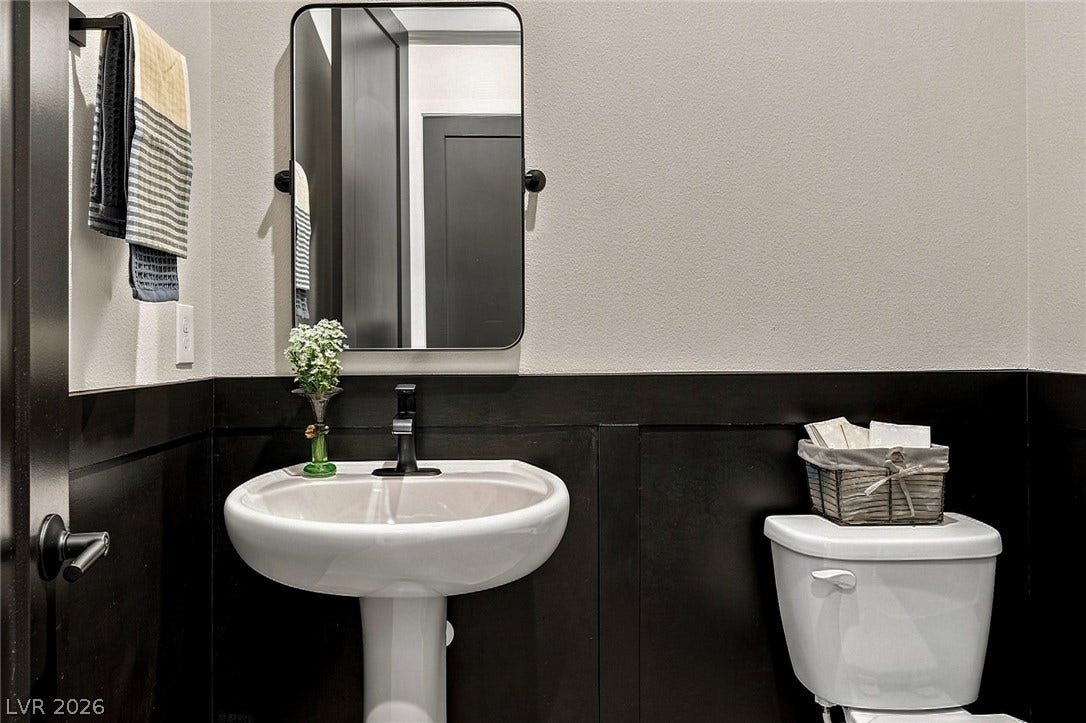 Bold wainscoting create a polished look in this powder room.