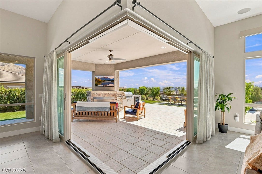 Seamless indoor-outdoor living flows through corner glass slider