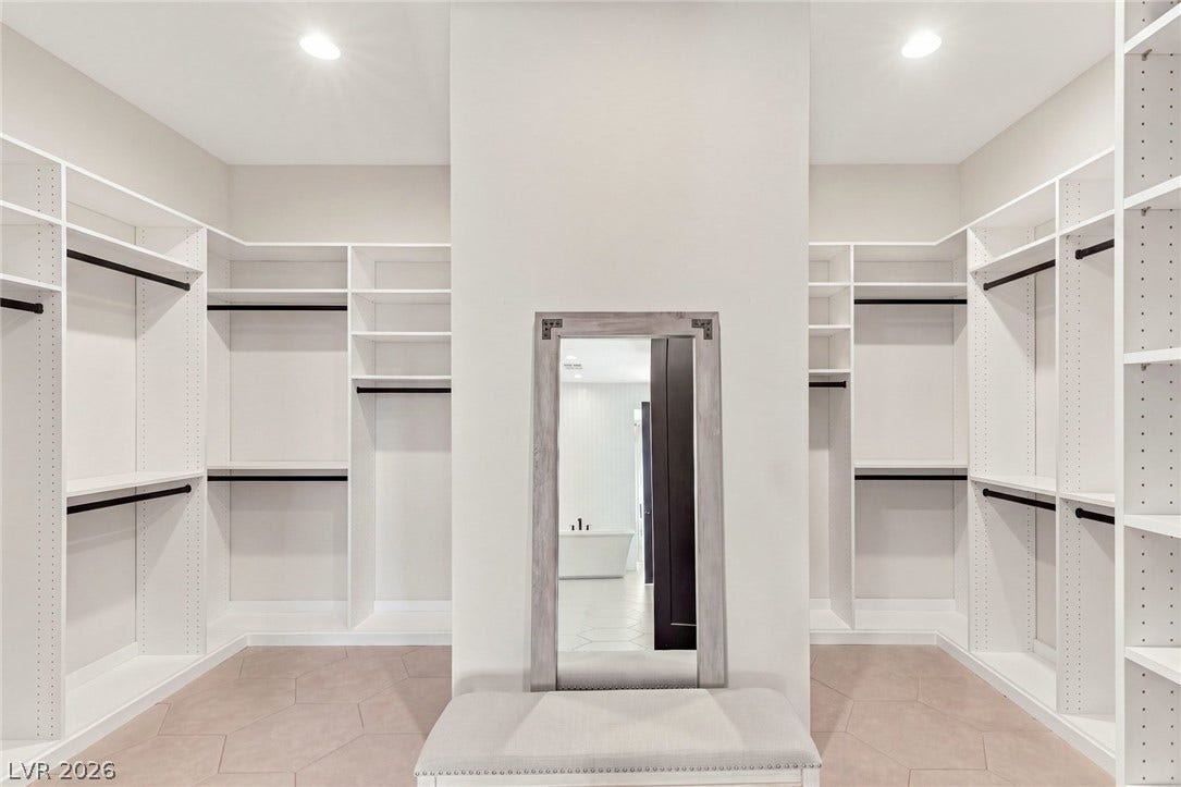 An abundance of built-in shelving in this custom  walk-in closet.