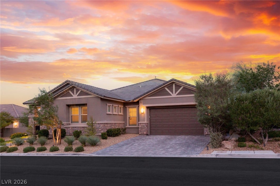 Exquisite stone accents and a paved driveway complement this contemporary single-story home.