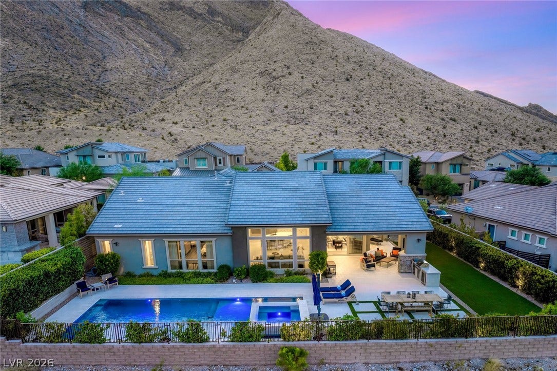 Dramatic mountain backdrops frame this modern desert home