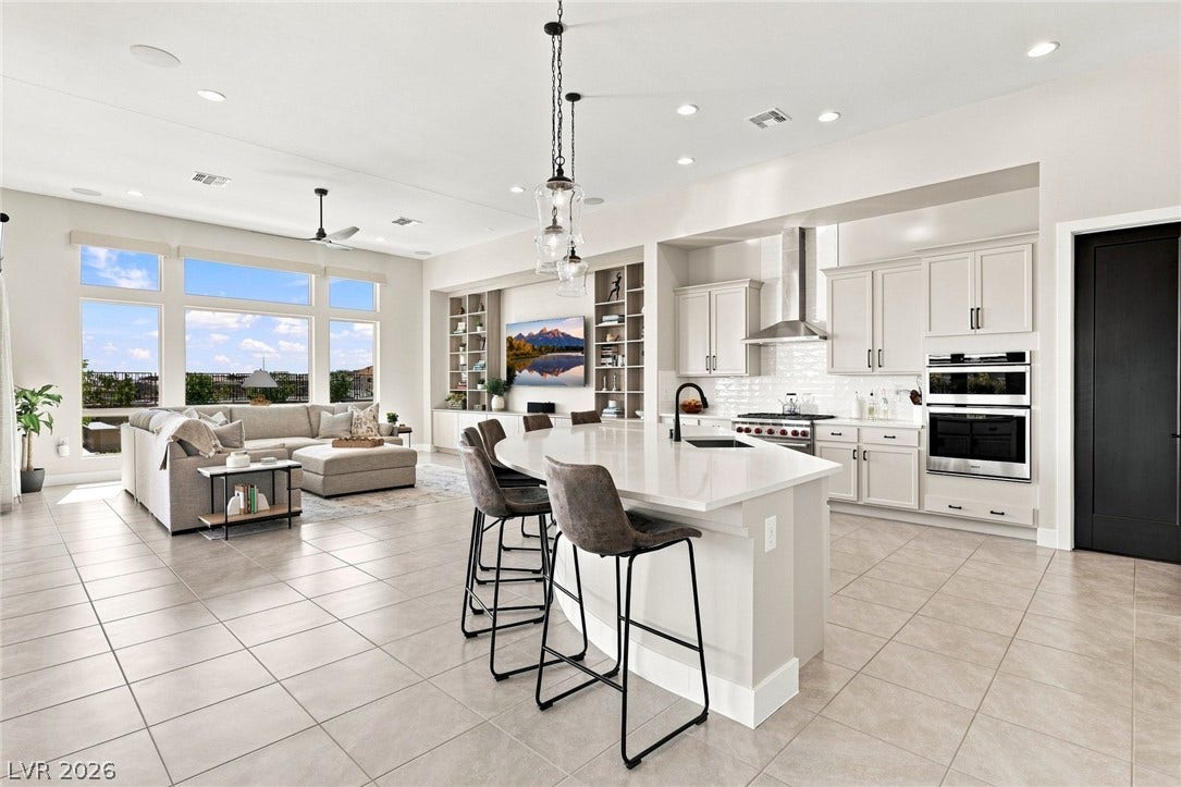 An open floorplan seamlessly connects the bright, modern kitchen to the inviting living area.