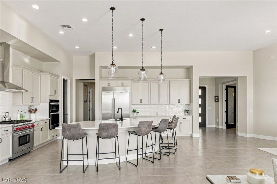 Gourmet kitchen features an oversized island and custom cabinetry.
