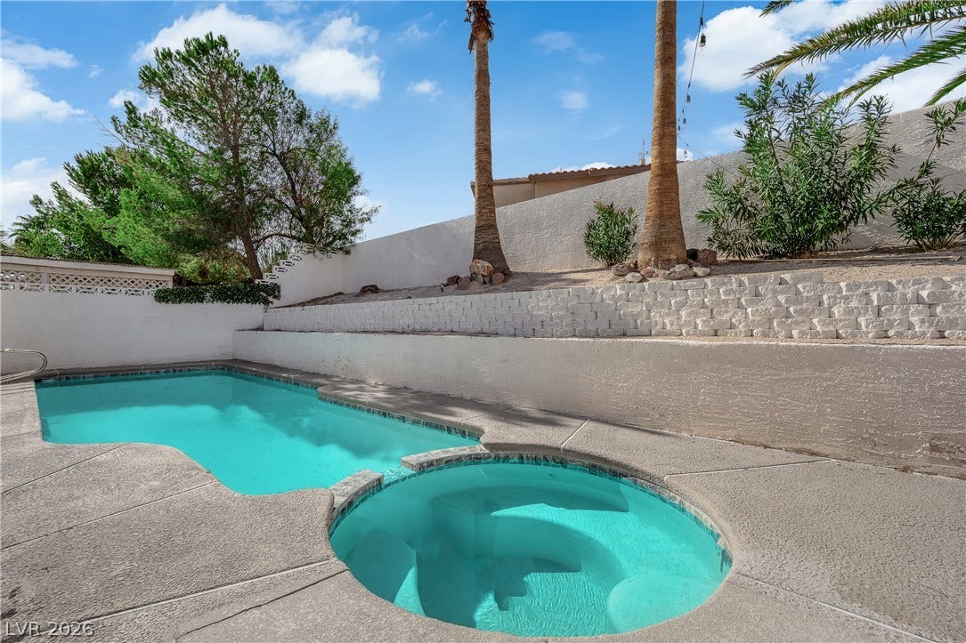1433 Pathfinder Road, Henderson, NV 89014 Terraced concrete retaining walls frame an in-ground swimming pool and integrated spa.