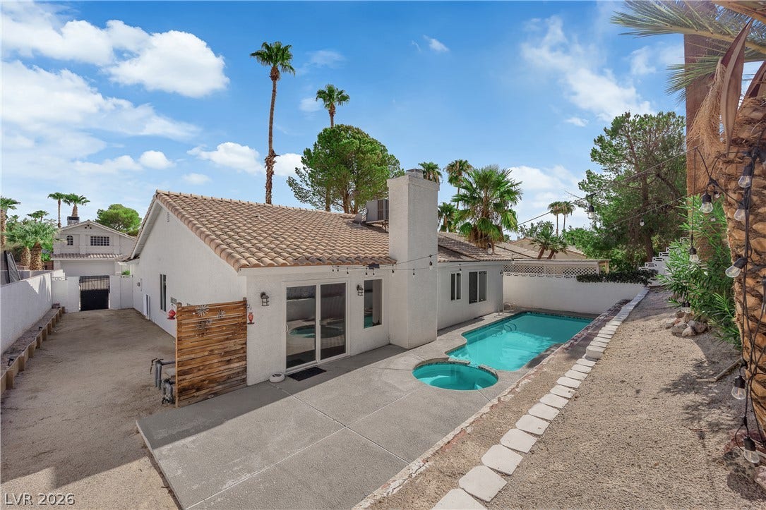 1433 Pathfinder Road, Henderson, NV 89014 An inviting backyard oasis features a concrete patio alongside a private pool and spa.