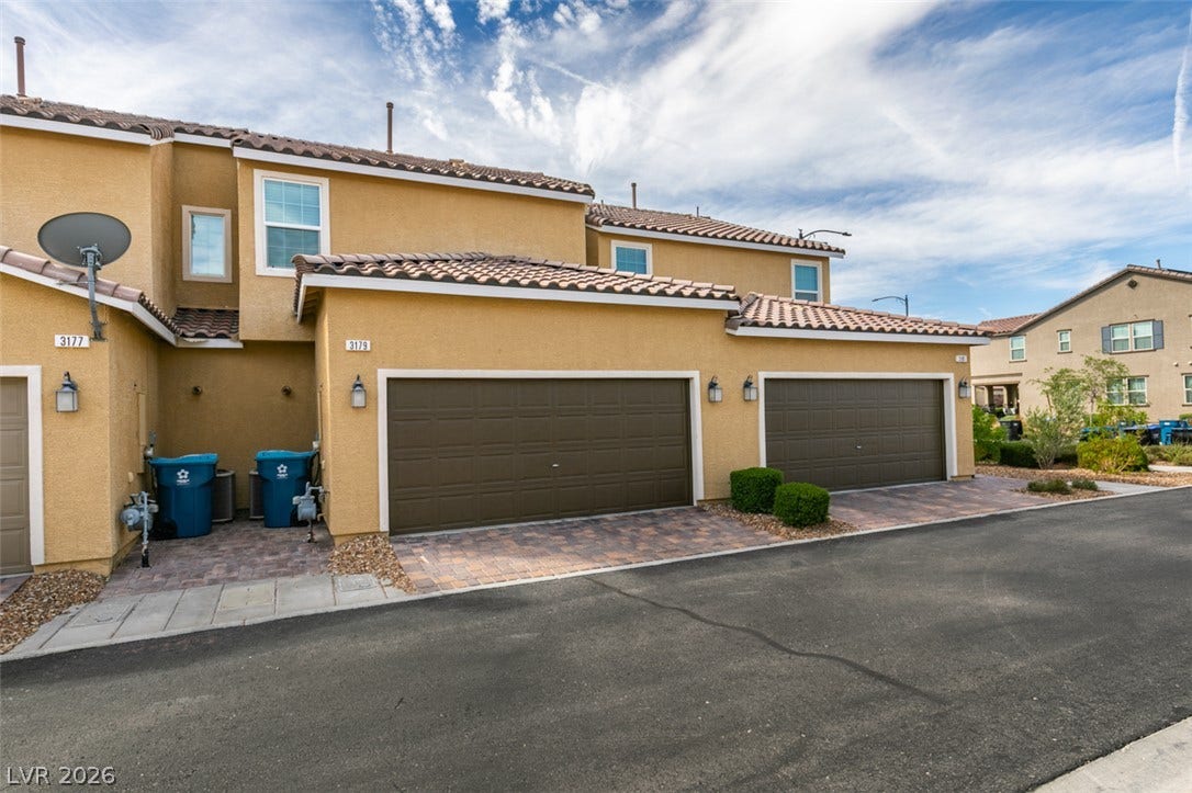 3179 Brynley Avenue, Henderson, NV 89044 Spanish tile roofing and stucco siding accent the exterior of this multi-level townhome.