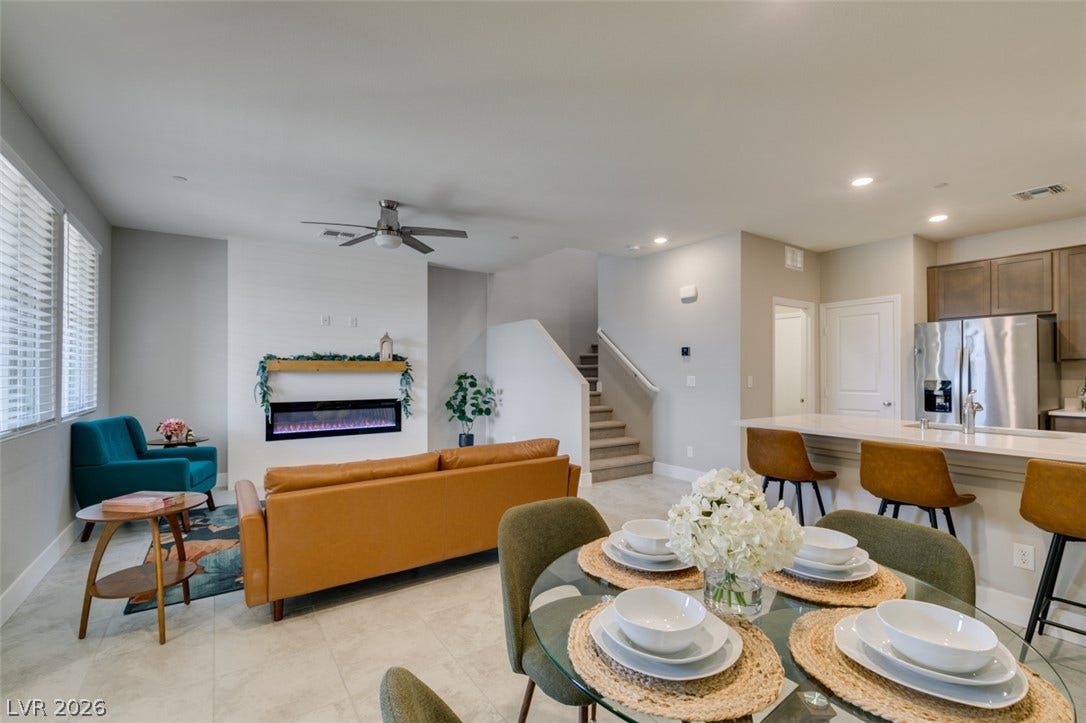 3179 Brynley Avenue, Henderson, NV 89044 An open floor plan connects the dining area, living room, and modern kitchen seamlessly.