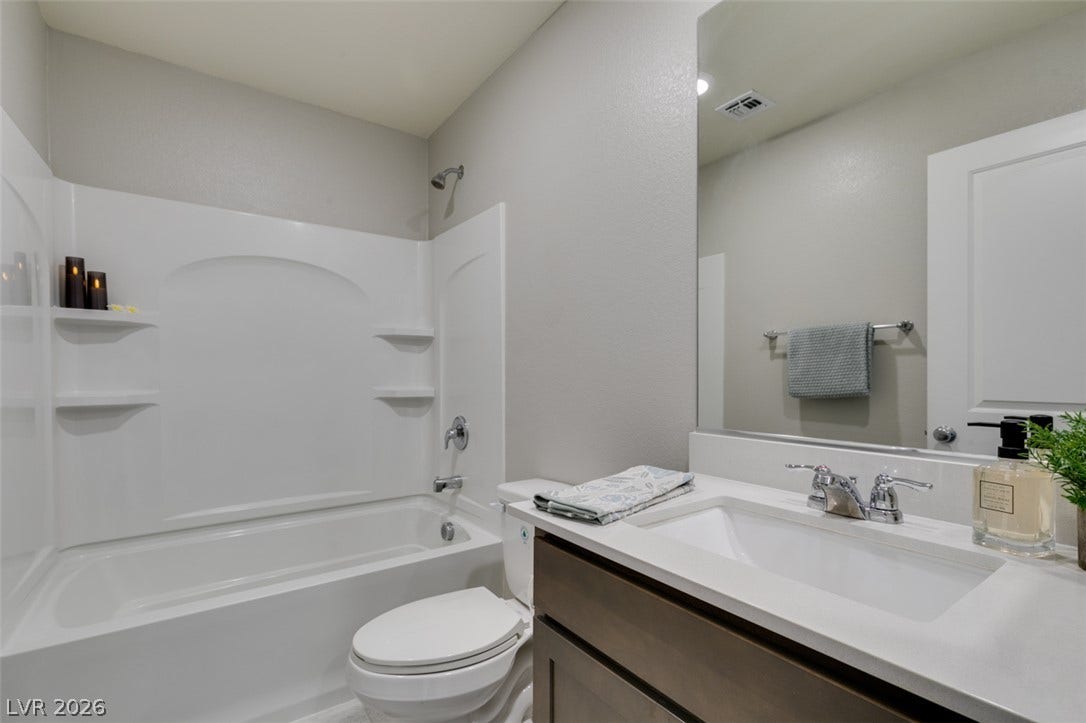 3179 Brynley Avenue, Henderson, NV 89044 An integrated tub and shower combination sits adjacent to a modern single-sink vanity.