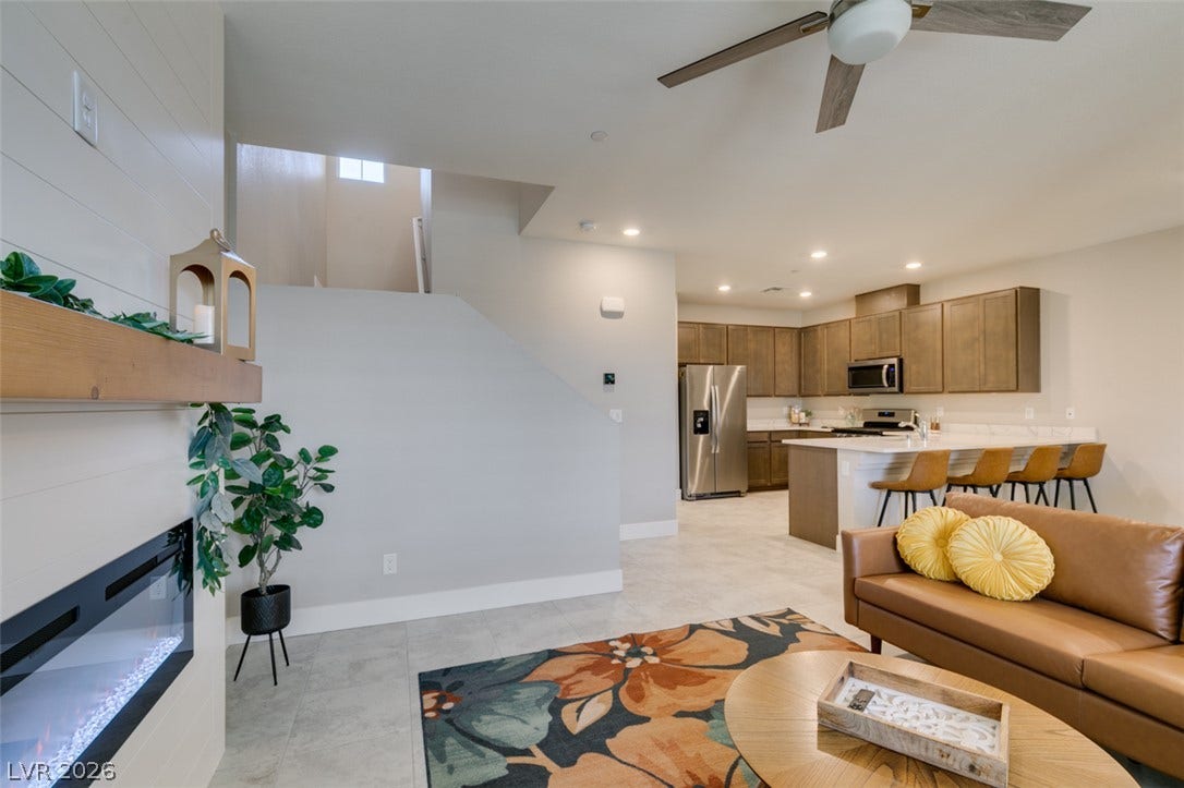3179 Brynley Avenue, Henderson, NV 89044 An open floor plan connects the living room fireplace to the kitchen area.