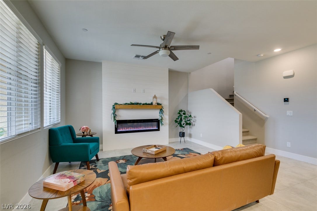 3179 Brynley Avenue, Henderson, NV 89044 Recessed lighting, tile flooring, and a modern fireplace elevate the open living area.