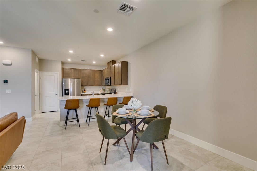 3179 Brynley Avenue, Henderson, NV 89044 Smooth tile flooring runs through this modern open dining space and adjoining kitchen.