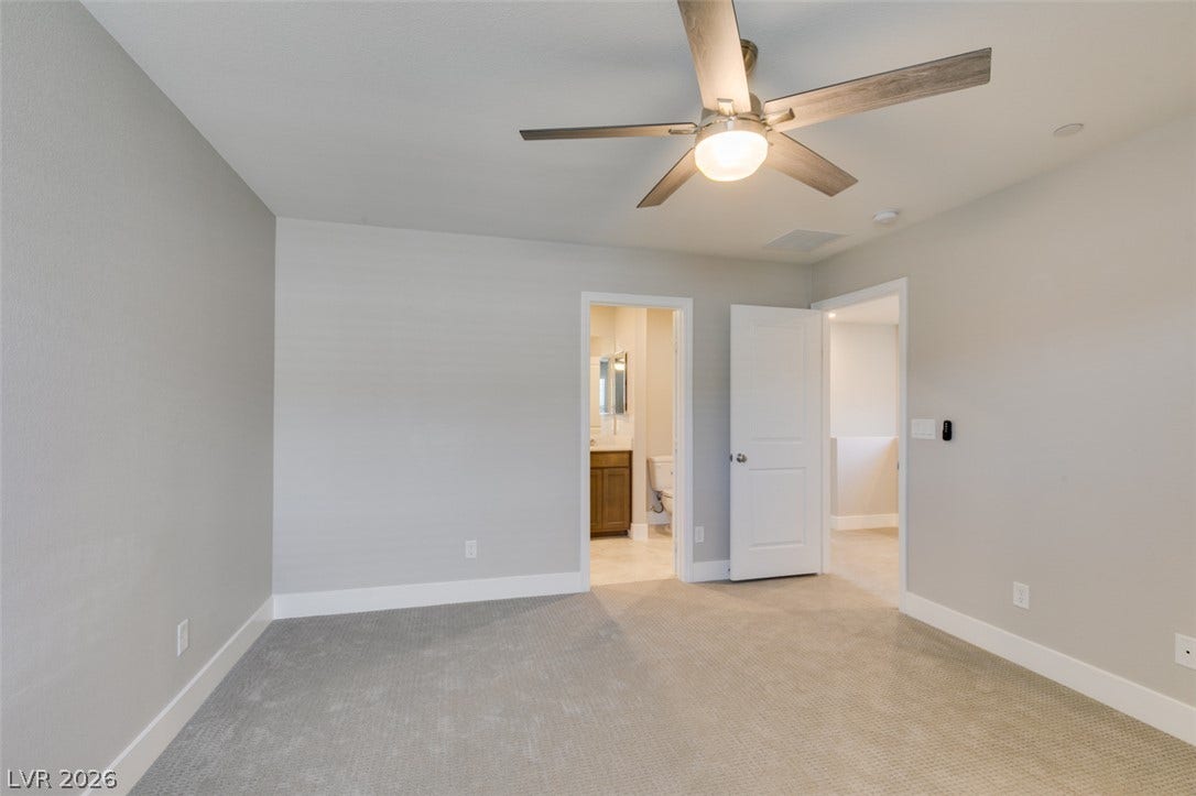 3179 Brynley Avenue, Henderson, NV 89044 Smooth plaster walls and soft carpeting define this versatile space adjacent to a private bathroom.