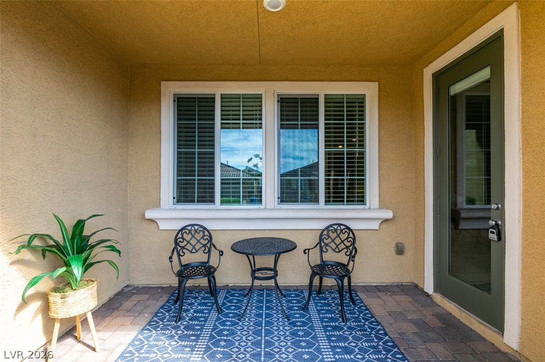 3179 Brynley Avenue, Henderson, NV 89044 A sheltered backyard patio features textured stucco walls and classic brick paver flooring.