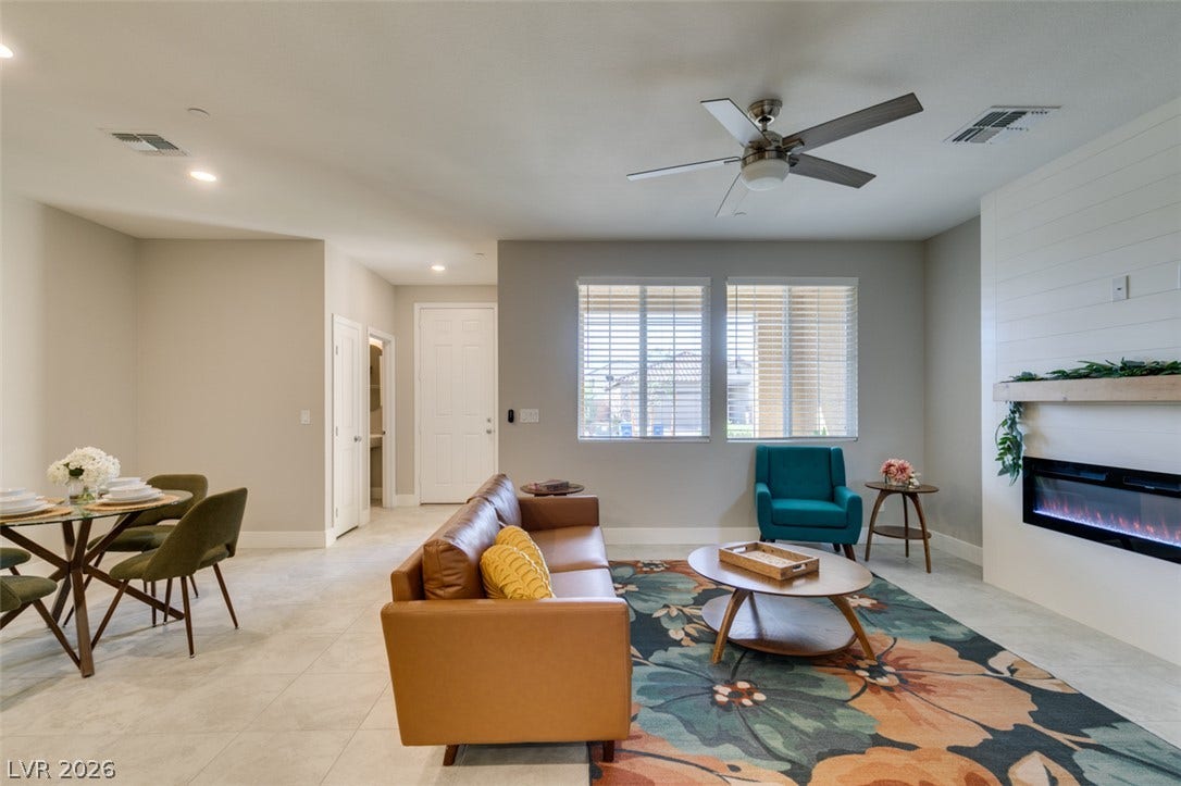 3179 Brynley Avenue, Henderson, NV 89044 An open living room showcases a modern fireplace insert set in shiplap wall details.