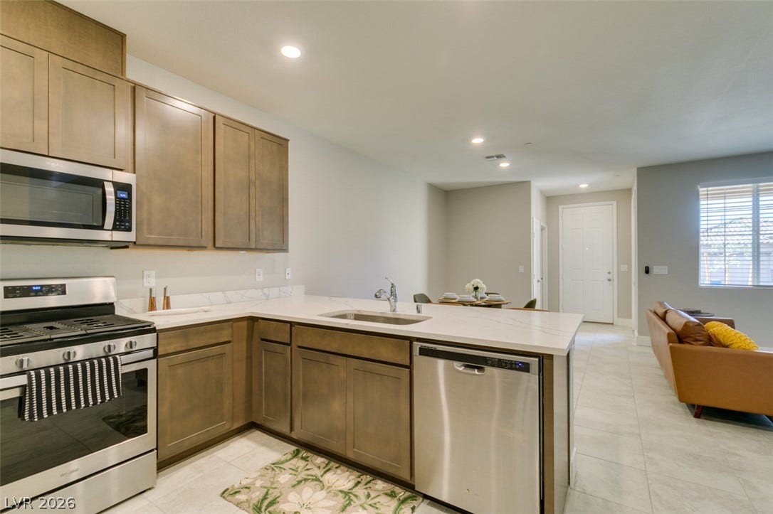 3179 Brynley Avenue, Henderson, NV 89044 Crisp quartz countertops and modern cabinetry highlight this open-concept kitchen space.