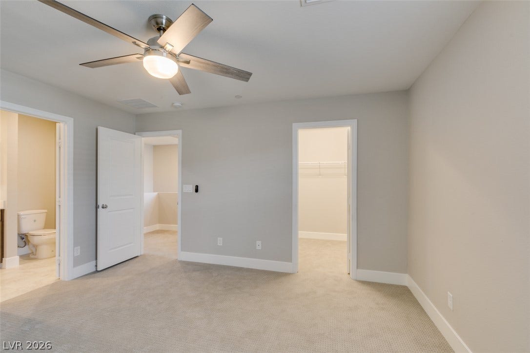 3179 Brynley Avenue, Henderson, NV 89044 Soft carpeting underfoot anchors this versatile space featuring an attached bathroom and walk-in closet.