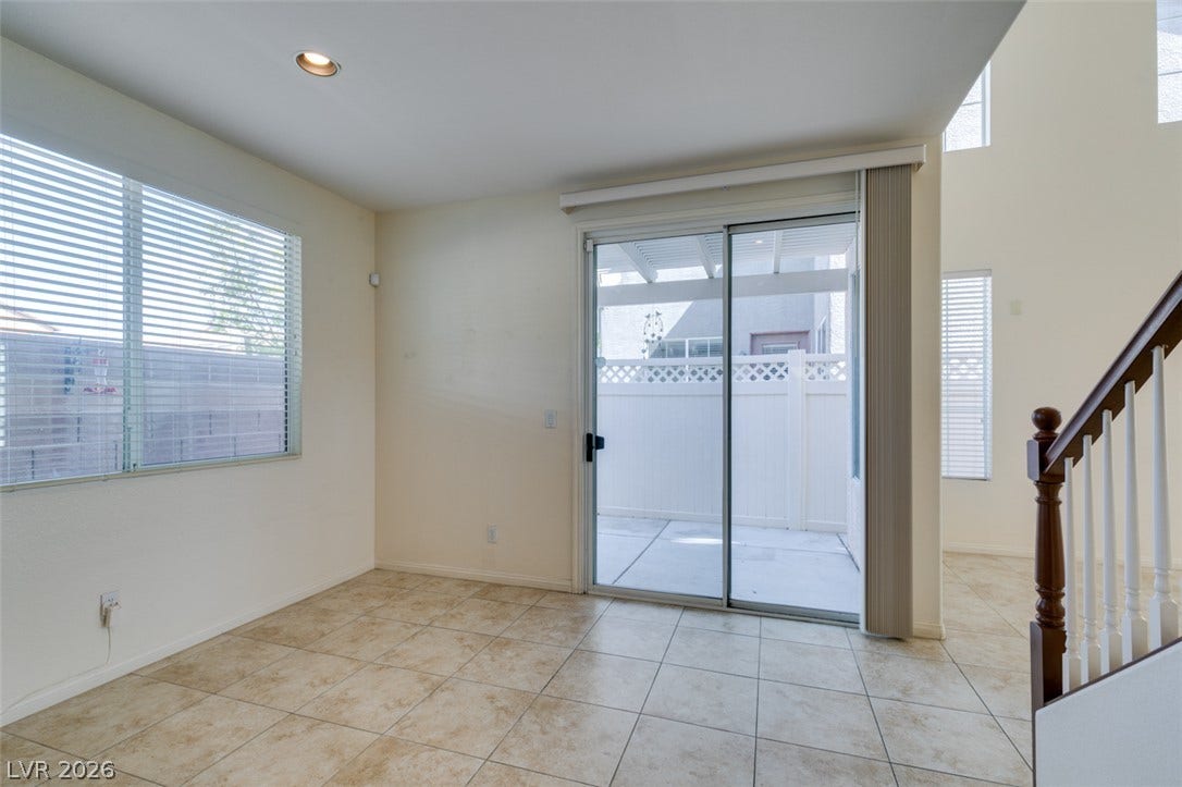 Sliding glass doors open directly to a private patio from this tile-floored dining area.