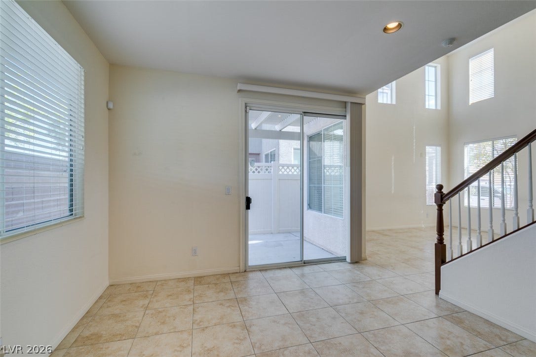 Tile flooring and sliding glass doors create a seamless transition to the outdoor patio.