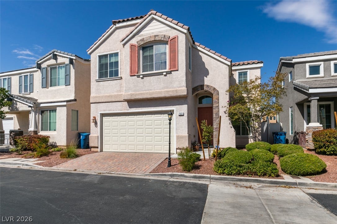 A classic stucco exterior and tiled roofline define this multi-level suburban residence.