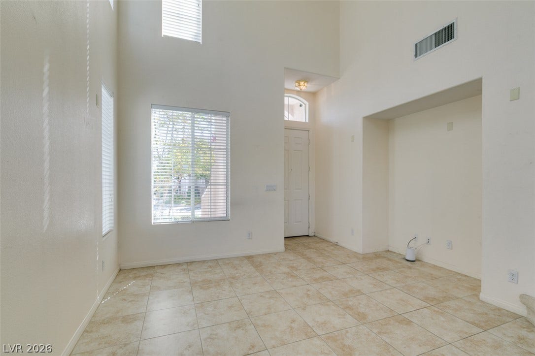 High ceilings and durable tile flooring define this airy entryway space.