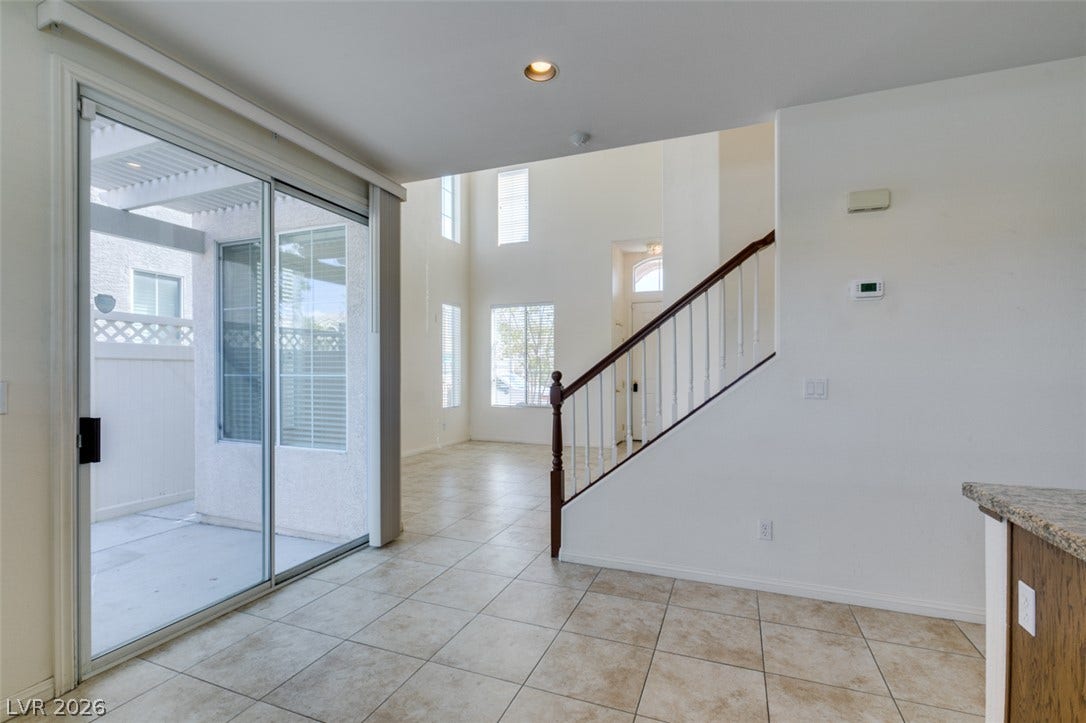 Tiled flooring and sliding glass doors create a seamless transition to the patio.