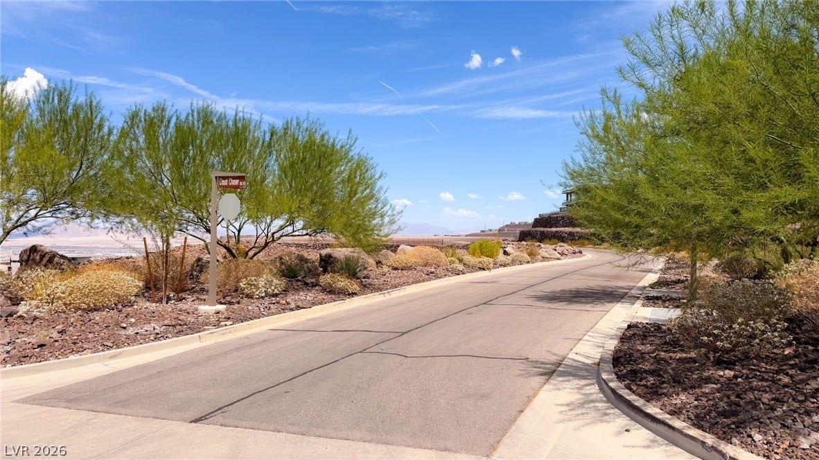 2 Epic View Court, Henderson, NV 89012 Desert landscaping and mountain vistas frame the paved neighborhood street under clear blue skies.